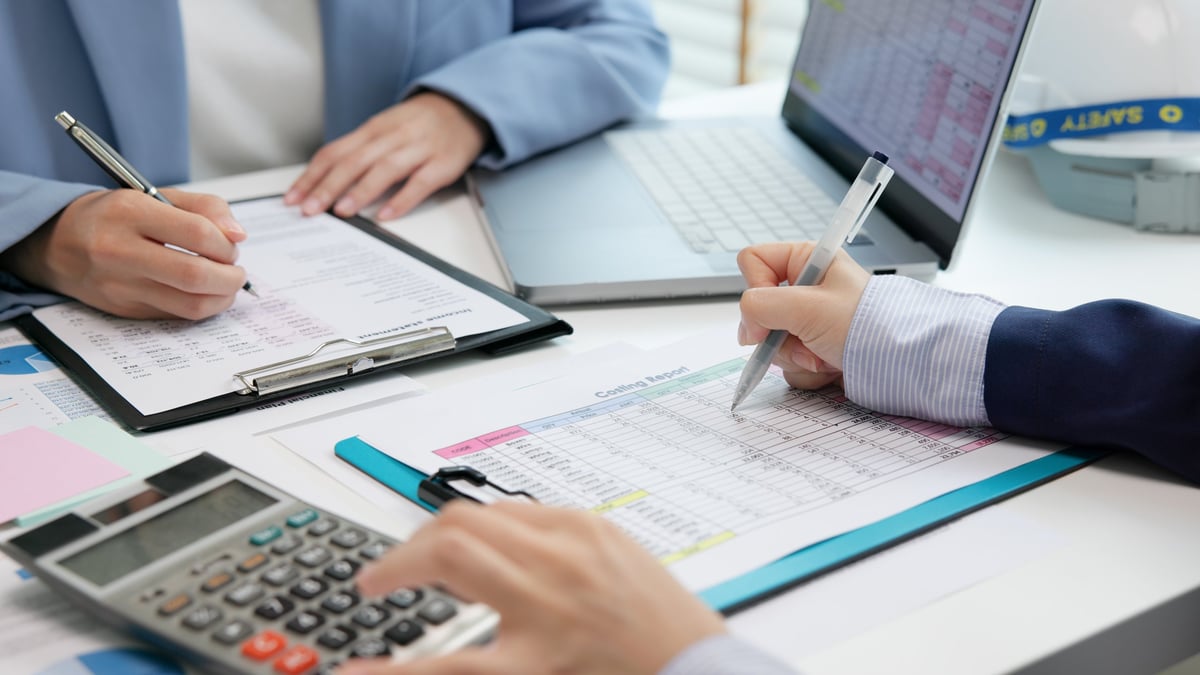 Accountant reviewing cost variance and budget reports in an audit office